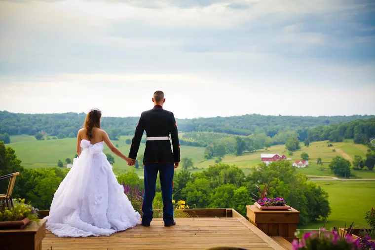 Couple holding hands facing the valley