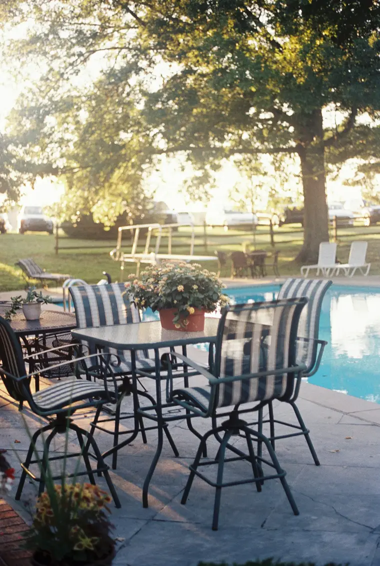 Poolside tables at golden hour on film
