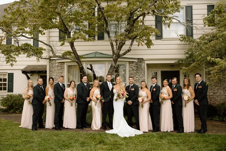 The wedding party in front of the house