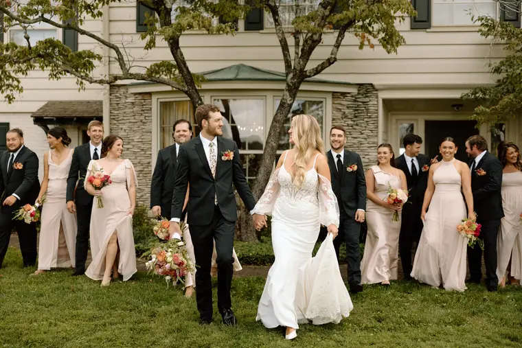 The wedding party walking up to the house