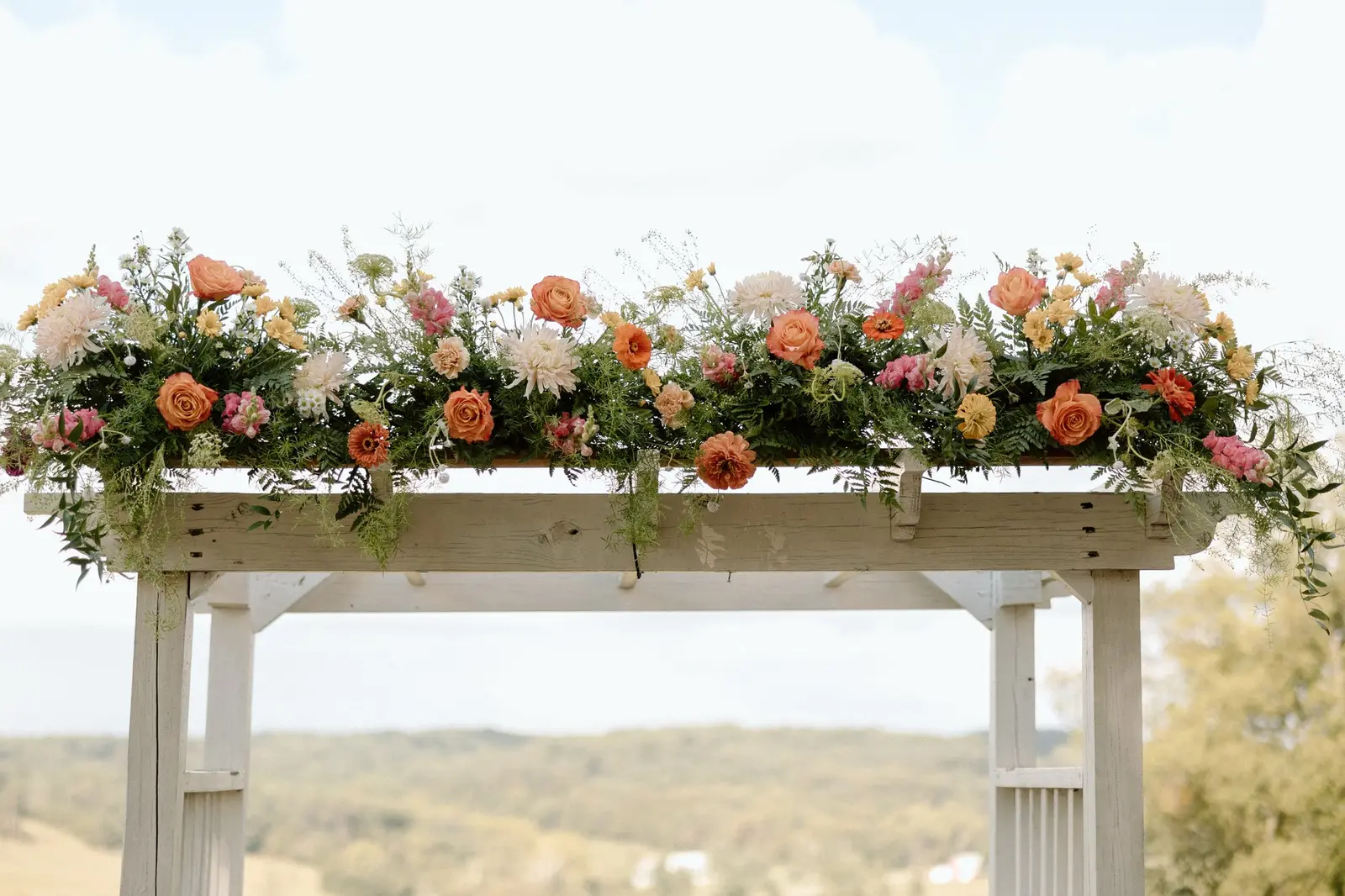 The arbor florals against the hills