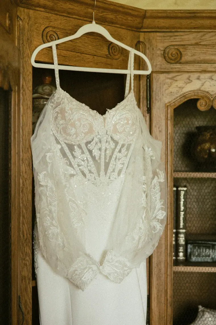 The gown bodice on its hanger