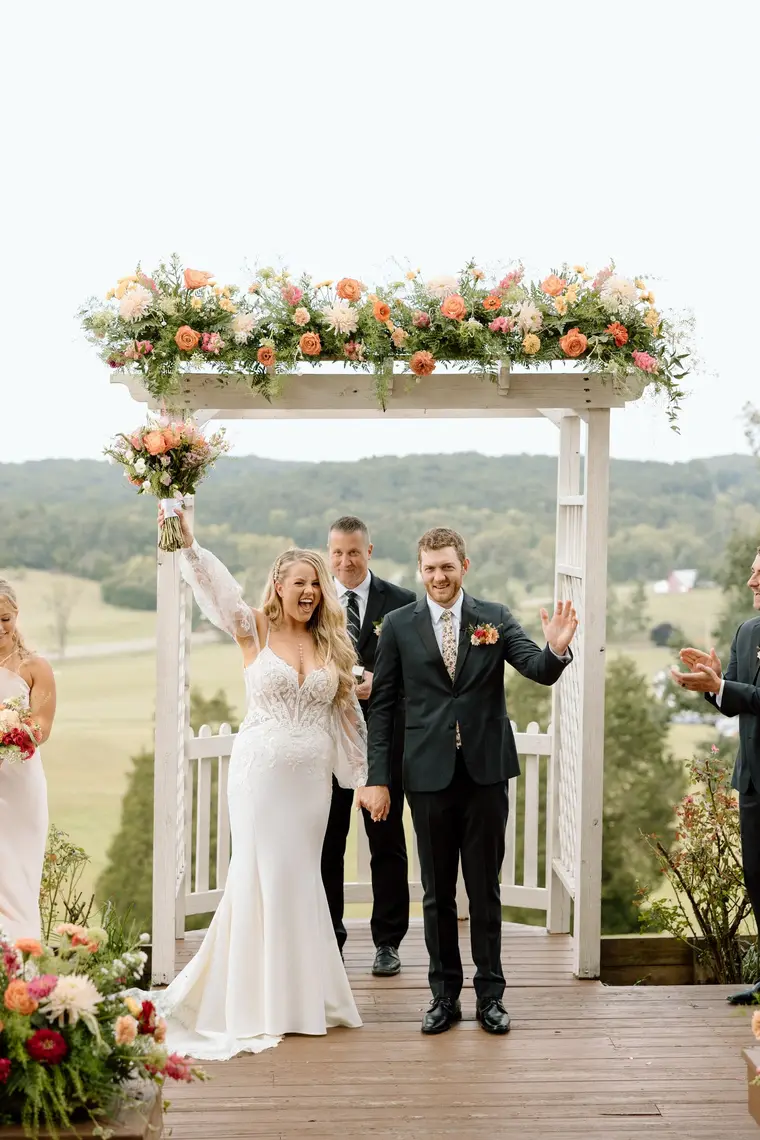 The bride cheering after the first kiss