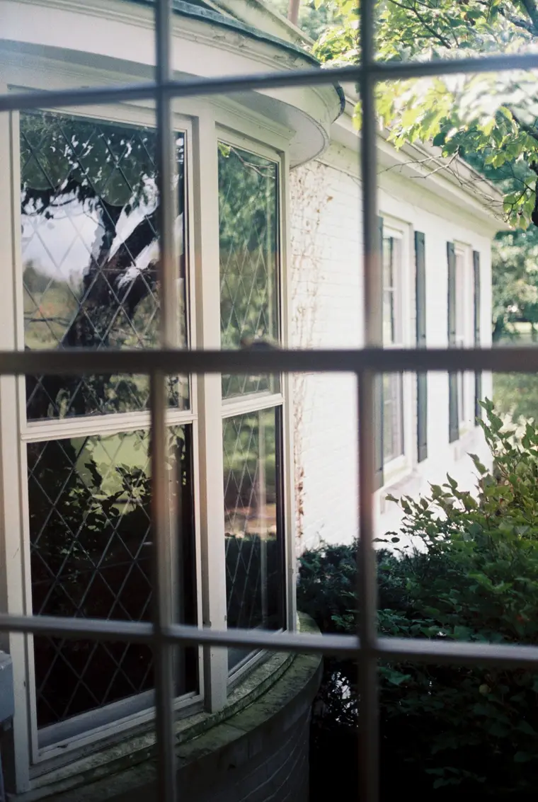 The house through an open window on film