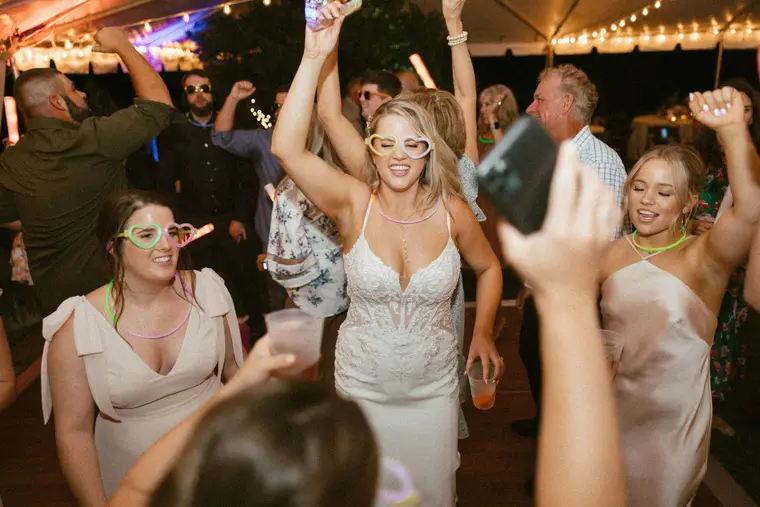 The bride dancing with her arms in the air
