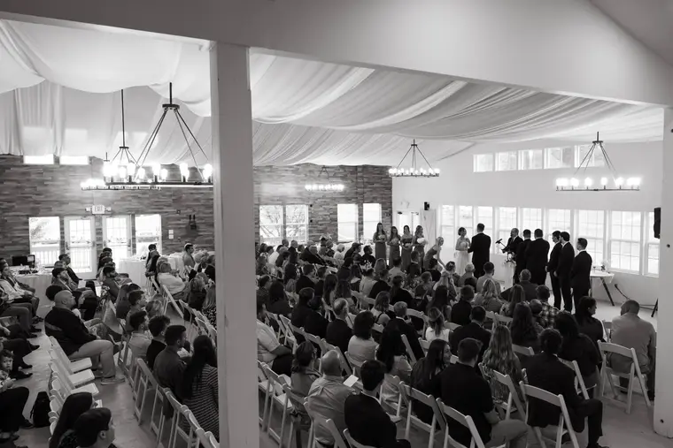 Black and white a full room during the ceremony