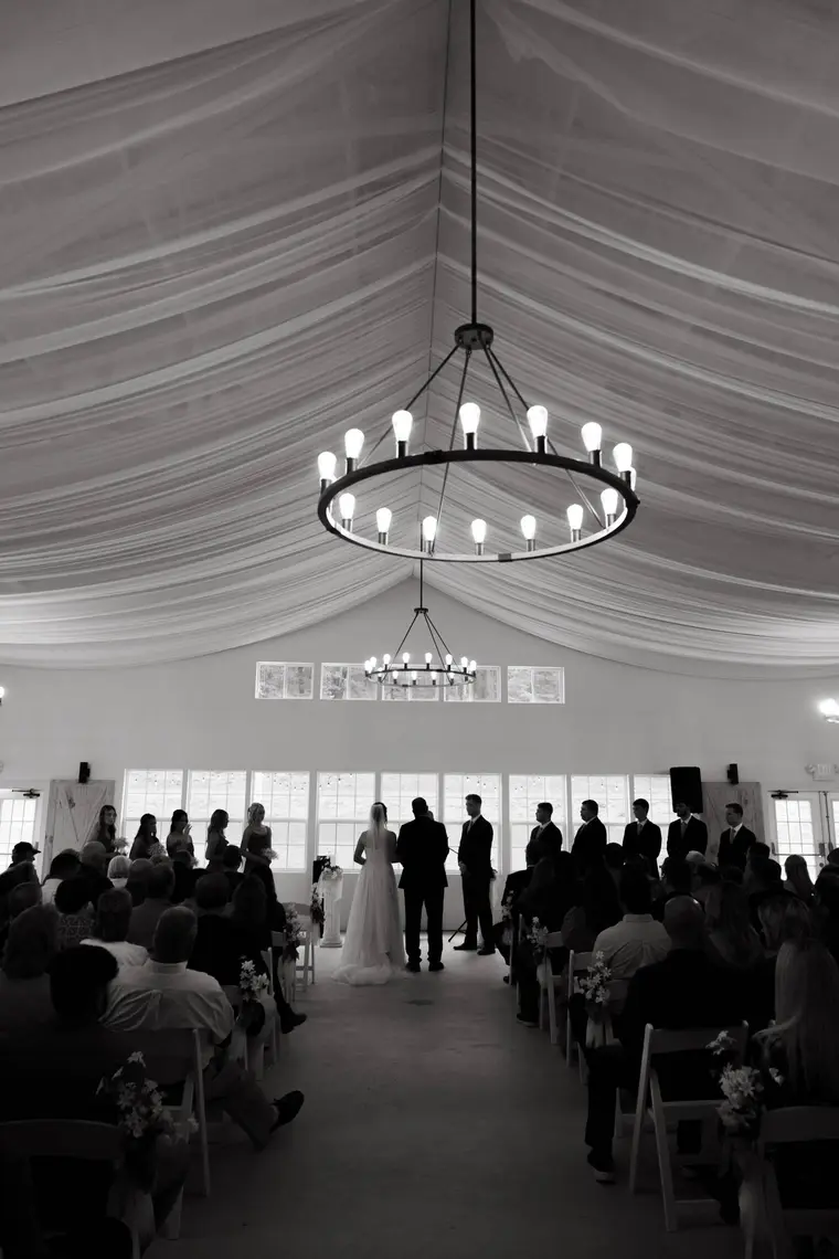 Black and white the ceremony beneath the chandelier