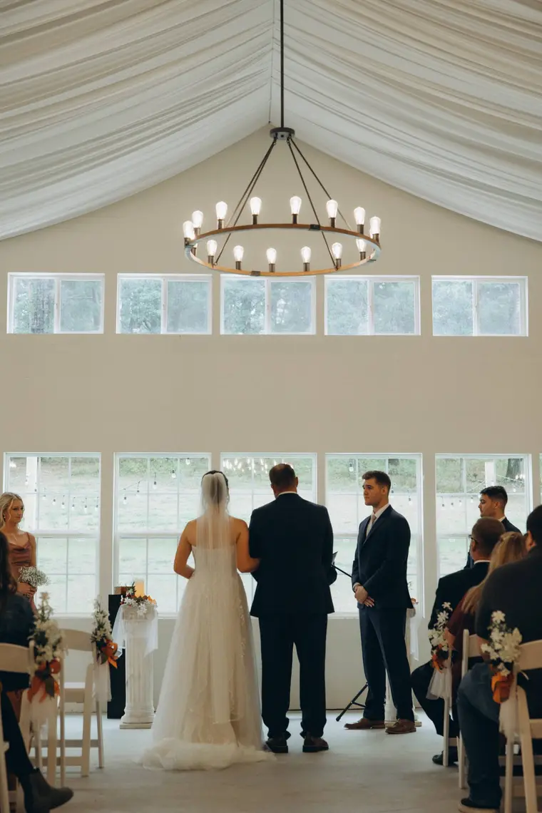 The ceremony beneath the chandelier